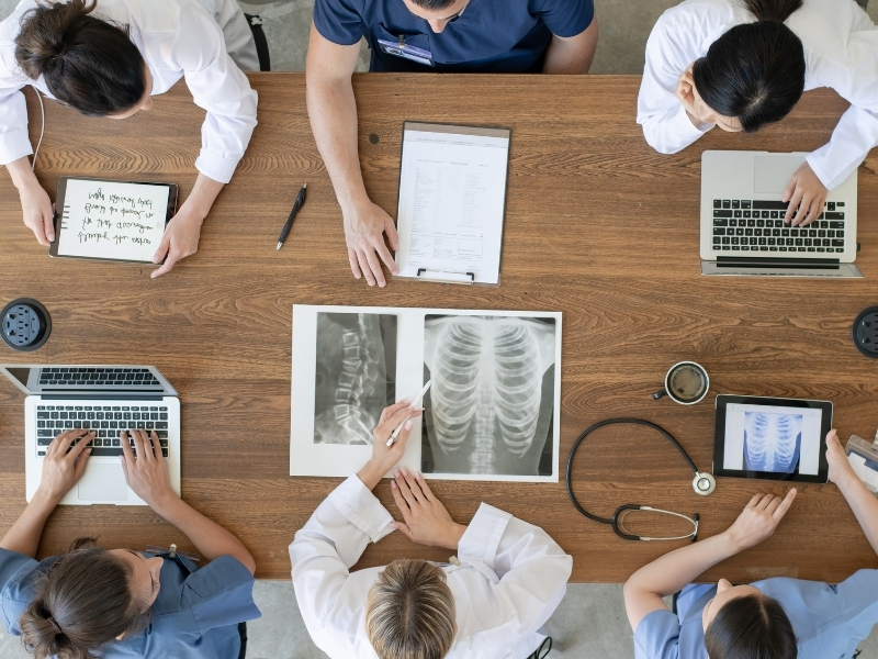 Overhead view of medical professionals seated at a conference table