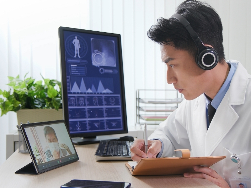 Doctor using a telemedicine session to see a patient